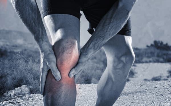 Male grabbing knee in pain, OA, OA clinical research